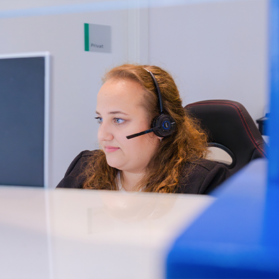 Mitarbeiterin am Empfang der Klinik beantwortet Telefonanrufe – freundlicher Service und professionelle Patientenbetreuung.